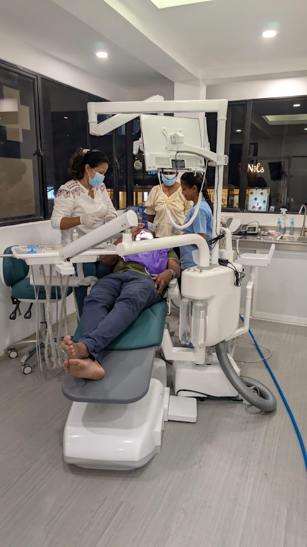 Dental treatment room with a patient in the chair and clinical equipment